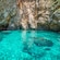 A body of water inside of a rocky inlet with rugged cliff walls